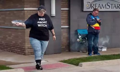 A planned parenthood escort burning incense.